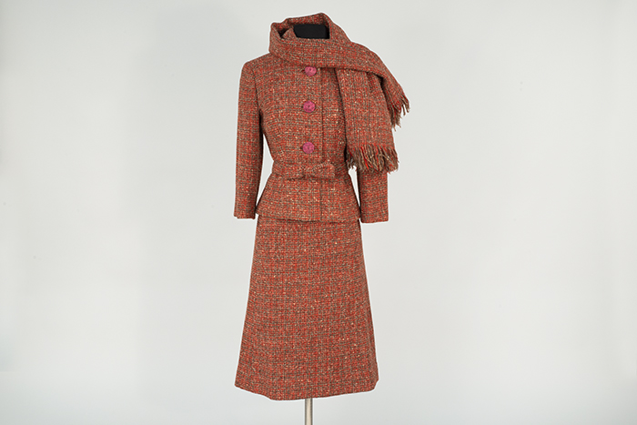Image of Red suit with stole, modeled in the Seattle World's Fair Fashion Pavilion, 1962
